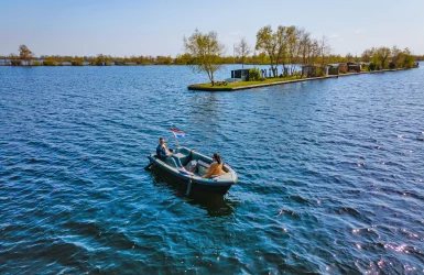 Een sloep vaart bij een eiland