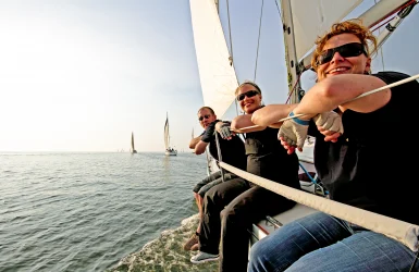Zeilers op zeilboot genieten