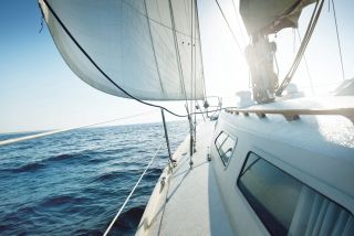 Zijaanzicht vanaf het dek van een zeilboot op open zee